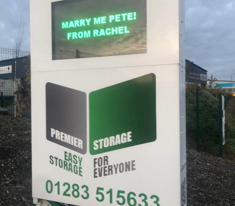 Couple propose via infamous Premier Container Storage giant LED sign on Cadley Hill Road.